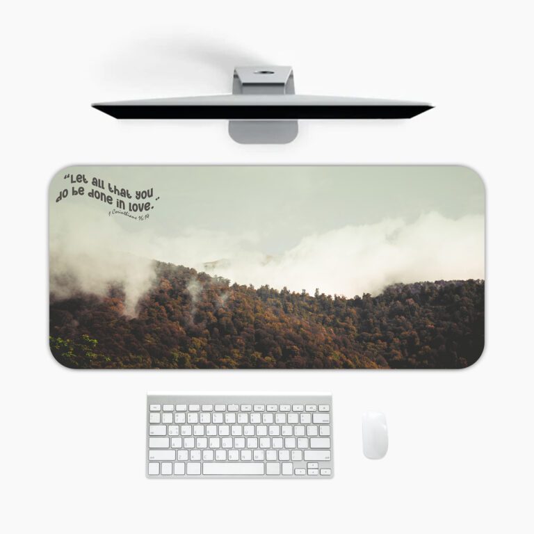 Infidu Misty Mountain Desk Pad featuring forested hills with fog, earthy colors, and the inspirational quote "Live as love did, and be made in love."