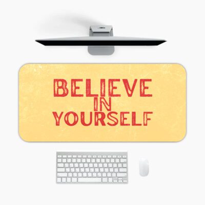 Infidu desk pad with bold red Believe in Yourself text on a soft yellow background and subtle vintage texture.