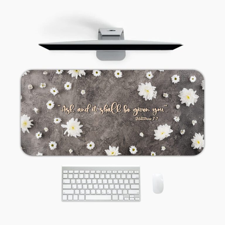 Dark grey desk pad featuring white daisies and the Bible verse "Ask and it shall be given to you" from Matthew 7:7 in golden cursive.