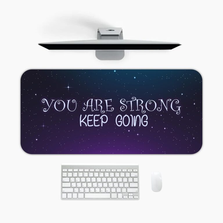 Infidu galaxy desk pad with “YOU ARE STRONG KEEP GOING” quote on a blue to purple starry background.
