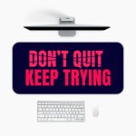 Infidu dark blue desk pad with bold red “DON’T QUIT, KEEP TRYING” motivational quote in the center.