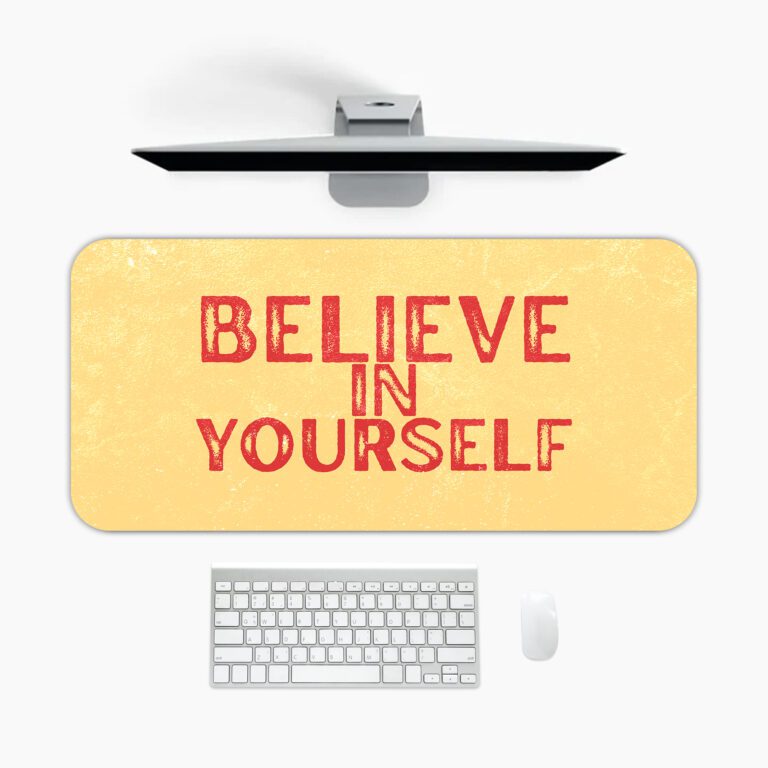 Infidu desk pad with bold red Believe in Yourself text on a soft yellow background and subtle vintage texture.