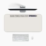 Infidu beige desk pad with motivational quote "HARD TIMES PASS STAY STRONG" and bold purple accent on a clean white background