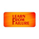 Infidu desk pad with bold red "Learn From Failure" quote on an orange to red gradient background.