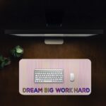 Infidu desk pad with pastel stripes and DREAM BIG WORK HARD quote on beige background.