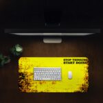 Infidu bold yellow desk pad with black grunge edges and motivational quote “STOP THINKING START DOING” in a vintage art style.