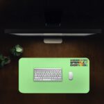 Infidu mint green desk pad with colorful “Kindness is free” quote and playful vintage-style design.