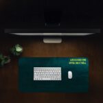 Infidu dark teal desk pad with yellow motivational quote and vintage textured design.