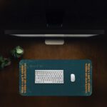 Infidu teal desk pad with vintage texture and vertical orange quote