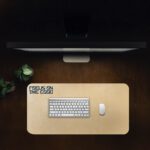 Infidu beige desk pad with motivational “Focus on the Good” quote in bold black text on a soft tan background.