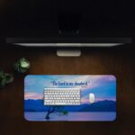Scenic desk pad with Bible verse and serene lake, tree, and pastel sky design.
