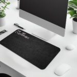 Infidu black desk pad with bold white "YOU ARE UNSTOPPABLE" text on a textured black background.