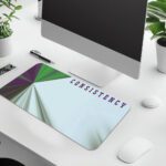 Infidu motivational desk pad with geometric burst and “CONSISTENCY” quote in purple on a light blue and white background.