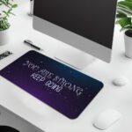 Infidu galaxy desk pad with “YOU ARE STRONG KEEP GOING” quote on a blue to purple starry background.