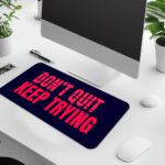 Infidu dark blue desk pad with bold red “DON’T QUIT, KEEP TRYING” motivational quote in the center.