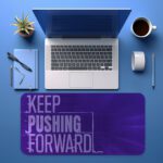 Infidu desk pad with bold “Keep Pushing Forward” quote on purple background and vintage art-inspired design.