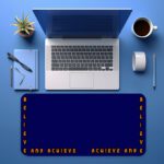 Infidu blue desk pad with “Believe and Achieve” quote in bold orange text on a deep blue background.