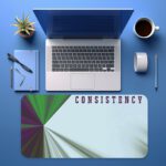 Infidu motivational desk pad with geometric burst and “CONSISTENCY” quote in purple on a light blue and white background.