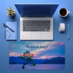 Scenic desk pad with Bible verse and serene lake, tree, and pastel sky design.
