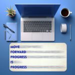 Infidu minimal cream desk pad with blue motivational quote "MOVE FORWARD PROGRESS IS PROGRESS" and subtle gray brush accents