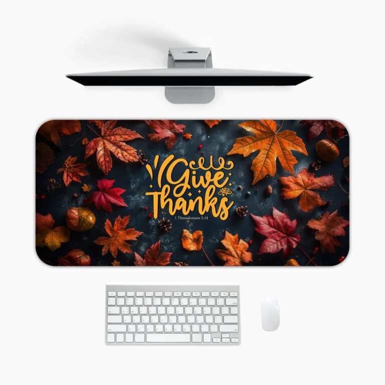 Vintage-style autumn desk pad with colorful fall leaves, acorns, and "Give Thanks" in golden-yellow calligraphy on a dark background.