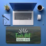 Infidu desk pad with green hills, blue mountains, and “Fear Not” Bible verse from Isaiah 41:10 in white and green, radiating peaceful vibes.