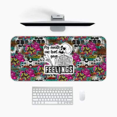 Infidu edgy desk pad with skulls, roses, leopard print, and the quote "My reality can hurt your FEELINGS" in bold lettering.