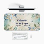 Infidu Summer Desk Pad with pastel watercolor background, green and blue leafy branches, and handwritten summer quote.