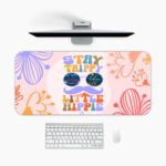 Groovy desk pad with “Stay Trippy Little Hippie” quote, bold floral background, cartoon mustache, and sunglasses in vintage art style.