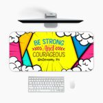 Colorful comic-style desk pad with bold triangular shapes, cartoon clouds, and “Be Strong and Courageous” Bible verse in vintage art style.