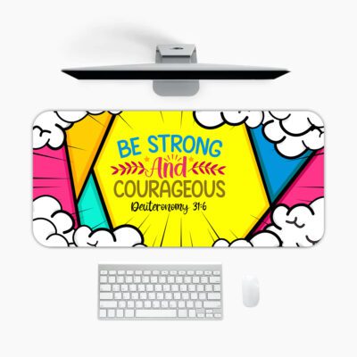 Colorful comic-style desk pad with bold triangular shapes, cartoon clouds, and “Be Strong and Courageous” Bible verse in vintage art style.