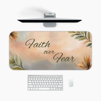 Pastel desk pad with “Faith over Fear” quote in script font, surrounded by watercolor-style leaves and flowers in soft, earthy tones.