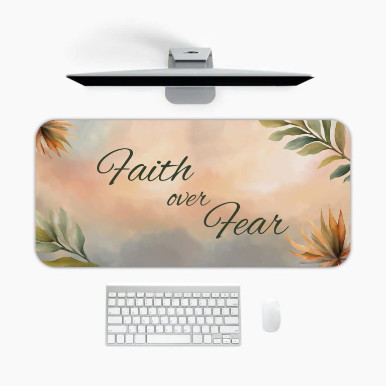 Pastel desk pad with “Faith over Fear” quote in script font, surrounded by watercolor-style leaves and flowers in soft, earthy tones.