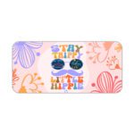 Groovy desk pad with “Stay Trippy Little Hippie” quote, bold floral background, cartoon mustache, and sunglasses in vintage art style.