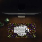 Dark floral desk pad with kaleidoscope pattern in purple, green, and orange, featuring “Just Do Good” quote in white framed text, vintage art style.