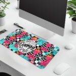 Infidu bold desk pad with colorful patterns and “Unleash the Energy” quote in a dynamic circular badge on a vibrant, high-energy background.