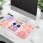 Groovy desk pad with “Stay Trippy Little Hippie” quote, bold floral background, cartoon mustache, and sunglasses in vintage art style.
