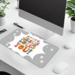 Light gray desk pad with “Jesus Loves You!” colorful text, surrounded by crosses, stars, hearts, smiley faces, and a happy emoji in vintage art style.