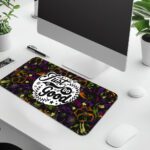 Dark floral desk pad with kaleidoscope pattern in purple, green, and orange, featuring “Just Do Good” quote in white framed text, vintage art style.