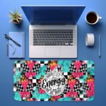 Infidu bold desk pad with colorful patterns and “Unleash the Energy” quote in a dynamic circular badge on a vibrant, high-energy background.