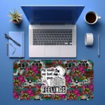 Infidu edgy desk pad with skulls, roses, leopard print, and the quote "My reality can hurt your FEELINGS" in bold lettering.