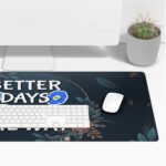 Infidu desk pad with floral vintage art and quote “Better Days Are On The Way” on a navy background with colorful flowers and golden lines.