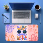 Groovy desk pad with “Stay Trippy Little Hippie” quote, bold floral background, cartoon mustache, and sunglasses in vintage art style.