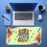 Retro desk pad with “Love Yourself” quote, bright yellow background, colorful geometric shapes, smiley faces, and flower icons in vintage art style.
